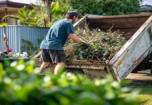 Garden waste being collected during landscaping work using skip bin hire Rockhampton prices services